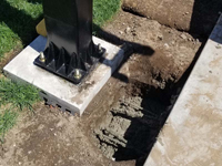 A look at one of the finer details of the Boston Hoop Head court, where the base of the goal system is being secured to the court base with rebar and concrete below the sod.