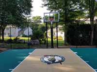 Small residential basketball court in Cranston, Rhode Island, featuring emerald green and sand tiles, and a custom Celtics logo