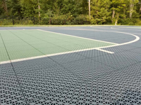 Closeup view of both shades of green Versacourt tiles on basketball court in Dartmouth, MA.