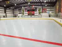 We traveled to Kapolei, Hawaii and inside to resurface two inline skate hockey rinks with Versacourt Speed Indoor tile. This is a look toward one end of the rink, from center line, showing it almost complete except edge tiles.
