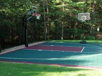Green and burgundy backyard basketball court installed in Kingston, MA.
