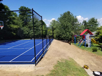 Monochrome blue hilltop home basketball court in Milton, MA.