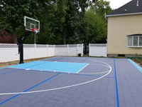 Residential backyard basketball court plus pickleball lines in Nashua, NH.