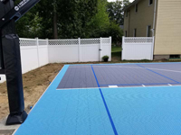 Residential backyard basketball court plus pickleball lines in Nashua, NH.