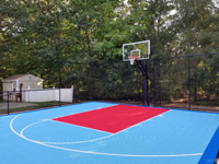 Light blue, red, and royal blue residential basketball court in North Attleboro, MA.