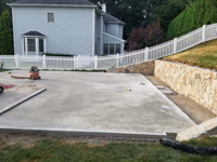 Cured concrete base being prepared to become a residential backyard basketball court in charcoal and titanium colors in Wellesley, MA.