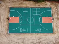 Multicourt with basketball, pickleball, shuffleboard and hoscotch as part of complete revamp of Yogi Jellystone Cranberry Campground in Cartver, MA, seen in close overhead view.