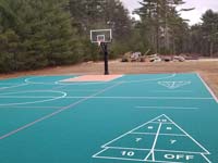 Multicourt with basketball, pickleball, shuffleboard and hoscotch as part of complete revamp of Yogi Jellystone Cranberry Campground in Cartver, MA, with good look at shuffleboard and pickleball lines usable with a portable net not shown.