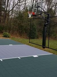 Dark green  and grey backyard basketball court in Agawam, MA.