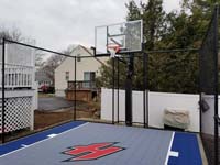 Small blue and grey basketball court with custom red H logo in Braintree, MA.