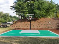 Emerald green and titanium Versacourt quality backyard basketball court in Bridgewater, MA.