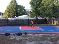 Lucky kid trying out mostly completed backyard basketball court in Canton, MA.