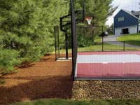 View of red and grey home basketball court in Groton, MA.