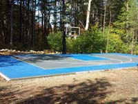 Backyard basketball court in Hanover, MA. Whatever your sport, you could have a court surface and accessories of your own.