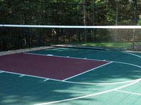 Optional tennis or volleyball net shown on multicourt basketball court in Kingston, MA.