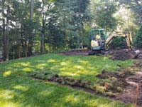 Removing lawn to make way for residential basketball court in shades of blue in Lexington, MA.