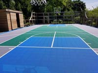 Existing grey, green and blue Versacourt to which we added new lines for pickleball and other sports besides basketball.