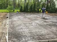 Form preparations for base construction for tan and green basketball court in Londonderry, NH.