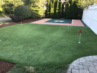 Backyard basketball court featuring Celtics logo and adjacent putting green by our partner is the sort of thing you might find in Manchester-by-the-Sea, MA or a yard like yours.