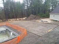 Form and reinforcement show prior to pouring cement base for green and black basketball court in Marion, MA.