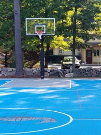 Large royal blue and titanium basketball court with golf seahorse logo at Bay Club in Mattapoisett, MA.