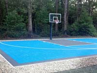 Residential basketball court in light blue and graphite colors, installed in a New England yard much like yours.