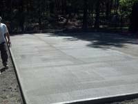 Curing the concrete base for a backyard basketball court in Kingston, MA.