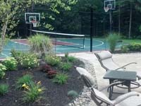 Backyard multicourt in Kingston, MA, featuring basketball, tennis, and shuffleboard.
