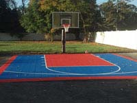 Sport and game courts can go on existing driveway or other asphalt surface. Shown is a small blue and orange driveway basketball court in southeastern Massachusetts.