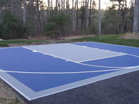 Small blue court for basketball on existing tarred driveway in Plympton, MA.