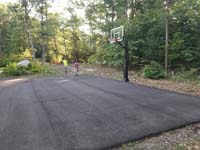 Blacktop court waiting to be improved with jade green and blue Versacourt low impact basketball tile Rehoboth, MA.
