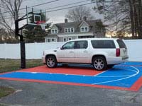 Car parked on court tiles installed on existing asphalt near Cape Cod.