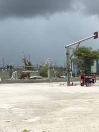 Replacement tennis and basketball courts in Codrington, Barbuda, courtesy of Australia, the Red Cross, and community effort, part of the ongoing recovery from hurricane Irma. Shown here, setting up to remove defunct goal post.