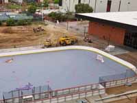 Rooftop view of right end of newly built and surfaced outdoor inline hockey court for Grand Canyon University in Phoenix, AZ.