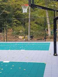 Fixed basketball goal at one end of a large multi-purpose basketball court in Bolton, MA.