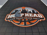 Close-up of stunning Hoop Head logo on key area of backyard Boston court installation.