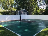 Closer view of the same green and black custom basketball court installation in Burlington, MA.
