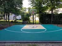 Small residential basketball court in Cranston, Rhode Island, featuring emerald green and sand tiles, and a custom Celtics logo.