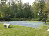 Full view of green basketball court from right front, angled slightly toward the left end, in Dartmouth, MA.