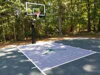 Slate green and titanium backyard basketball court with Michael Jordan custom logo in Duxbury, MA.
