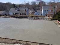 Smoothing the cement poured for concrete court base in Hingham, MA.