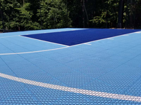 Close view of portion of light blue and navy blue court surface tiles in Medway, MA.