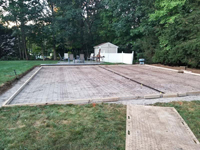 Light blue, red, and royal blue residential basketball court in North Attleboro, MA. Form for pouring cement for court base shown here.
