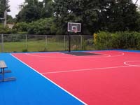 Near identical finished picture to compare to the before picture of resurfaced town basketball court in Paxton, MA.