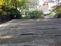Part of the spot where a large Raynham, MA basketball court will be when finished, after much digging, filling, grading, and creating a stable, level surface to put a concrete base before laying tiles.