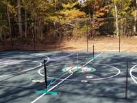 Portable net and other accessories for pickleball in center of basketball and multicourt in Raynham, MA.