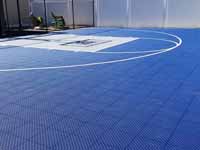 Royal blue and ice blue basketball court in Revere, MA. This was installed on existing concrete that included a cap on a filled in pool.