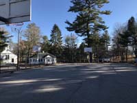 Before picture down most of the length of original asphalt basketball court at Camp Wonderland in Sharon, MA.