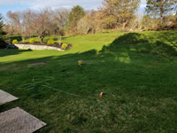 View of the area in grassy yard where a small home basketball court will be installed in Southborough, MA.