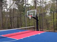 Backyard basketball court, with adjustable center net making it a multicourt for other games, in Sudbury, MA.